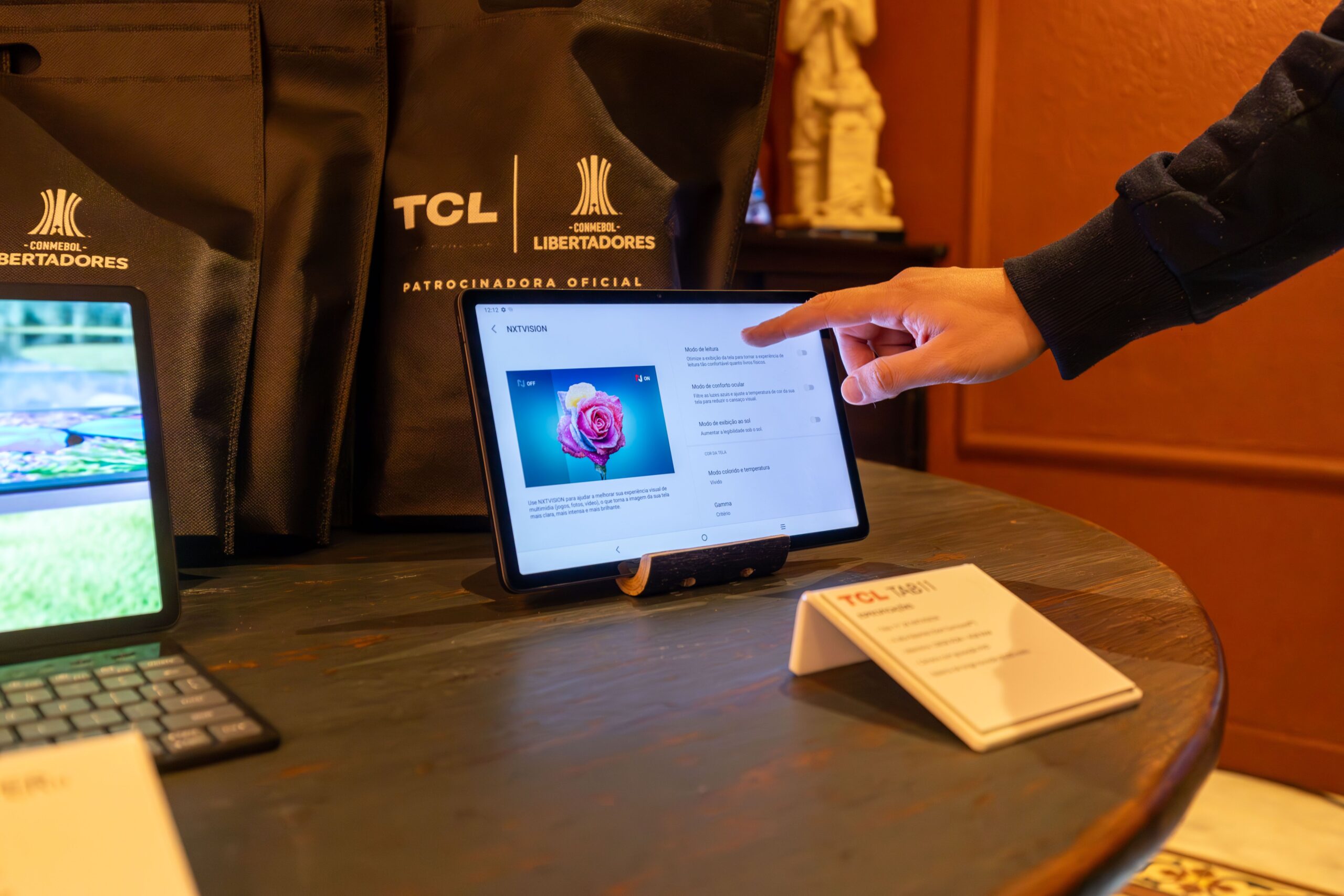 Flat lay of the Amazon Fire HD 10 tablet in Black on a marble surface with a streaming app open on the vibrant 10.1 inch 1080p Full HD display. Wireless earbuds, coffee cup, and notebook arranged around the tablet showing a relaxed entertainment setup. Text overlay displaying 53% off deal at $72.99.